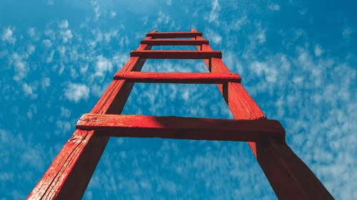 Red Staircase Rests Against Blue Sky, Front View. Development Motivation Career Growth Concept