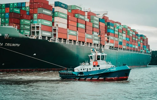 a little pilot boat helping the big ships around.